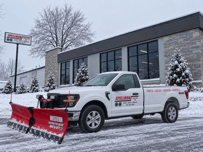 snow plow in front of spellman store
